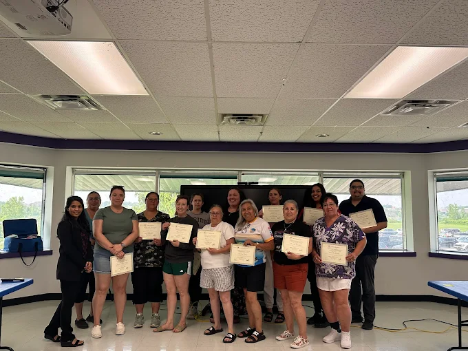 students-holding-phlebotomy-certificates Phlebotomy and medical training graduates proudly displaying certificates after course completion at training center