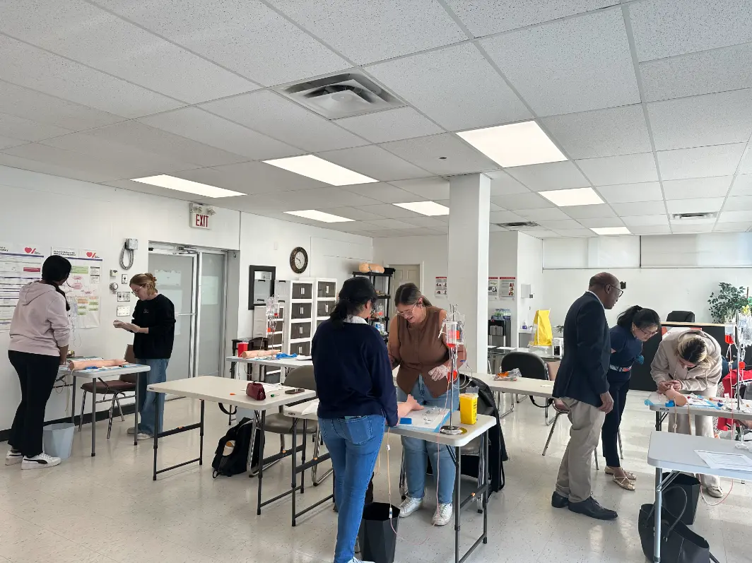 Students practising hands-on skills in groups across a Medical Training Center classroom