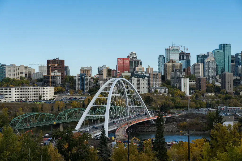 Edmonton skyline with Walterdale Bridge spanning North Saskatchewan River, modern downtown buildings and urban cityscape in Alberta Canada