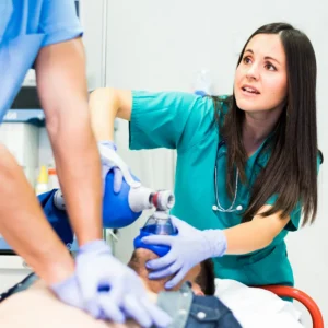 Emergency medical team performing CPR with bag valve mask ventilation on patient in hospital emergency room, nurse and paramedic providing life-saving care